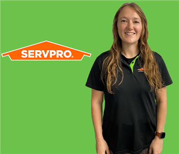 Women in front of SERVPRO Green and Logo